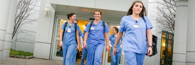 A group of young nurses walk together.